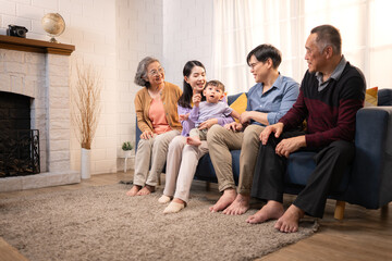 Happy multi-generational Asian family enjoying quality time together at home