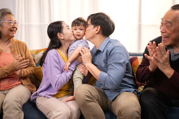 Happy multi-generational Asian family enjoying quality time together at home