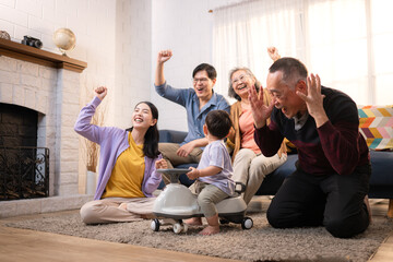 Happy multi-generational Asian family enjoying quality time together at home