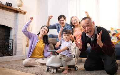 Happy multi-generational Asian family enjoying quality time together at home
