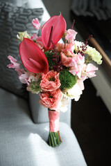 Vibrant floral bouquet showcasing a mix of exotic anthuriums, lush roses, and delicate snapdragons...