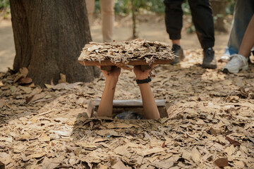Cu Chi Tunnels. Tourists try to enter the underground tunnels. These tunnels were used in the...