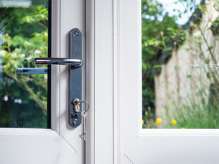 Key in closed door looking out onto garden