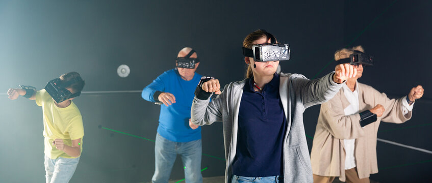 Teenage girl using virtual reality glasses with her family