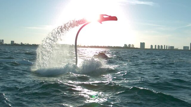 Water hoverboard soaring over sea in glow of sunset - super slow motion at 1000 FPS