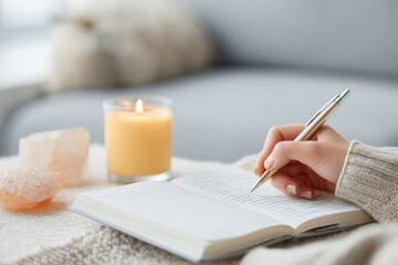 Fototapeta premium Person writing affirmations in notebook feels happy and content