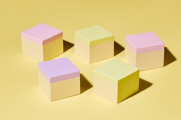 Obraz premium Pastel cubes on a yellow background