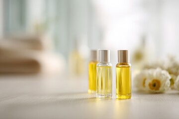 minimalistic arrangement of skincare oils where focus is solely on bottles with people in background artistically blurred