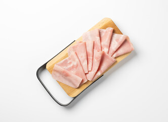 Sliced cooked ham neatly arranged on a wooden serving board with black handles, placed on a white...