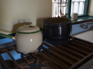 Rustic vintage kitchen scene with vintage pots on an old stove.
