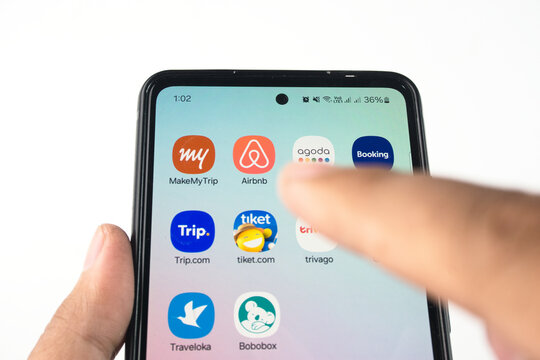 Mobile Phone Screen Displaying Popular Travel Application Icons such as MakeMyTrip, Airbnb, Agoda, Trivago, Traveloka, OYO, Bobobox, Booking.com, Trip.com, and Tiket.com on February 15, 2025 in Sleman