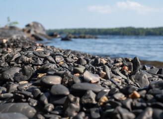 Black shungite pebbles on the beach of Lake Onega in Karelia
