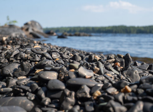 Black shungite pebbles on the beach of Lake Onega in Karelia