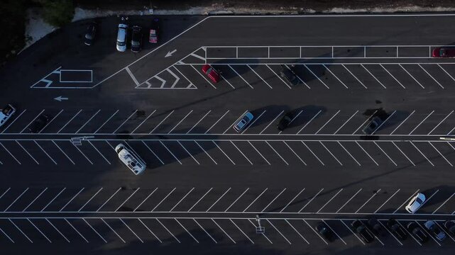 Aerial overhead view of newly paved half empty parking lot