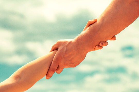 Friendly handshake. Two hands, shaking hands. Rescue, helping gesture or hands. Close up help hand. Helping hand concept, support