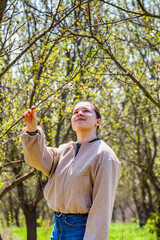 Beautiful young woman near blooming spring tree. Youth, love, fashion, romantic and lifestyle concept.