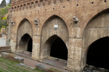 Facade of the medieval fountain of Fontebranda, the oldest one in Siena, Italy.