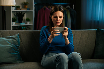 Woman Enjoys Watching Video on Smartphone While Relaxing