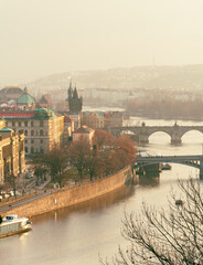 Prague riverside with Charles Bridge in afternoon light