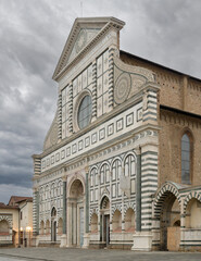 Facade of Santa Maria Novella in Florence, Italy, completed by Leon Battista Alberti in 1470, combining Renaissance and Gothic styles in marble.