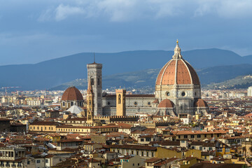 Panoramic view of Cathedral of Santa Maria del Fiore with Giotto's Campanile and city rooftops in Florence, Tuscany, Italy. © dimamoroz