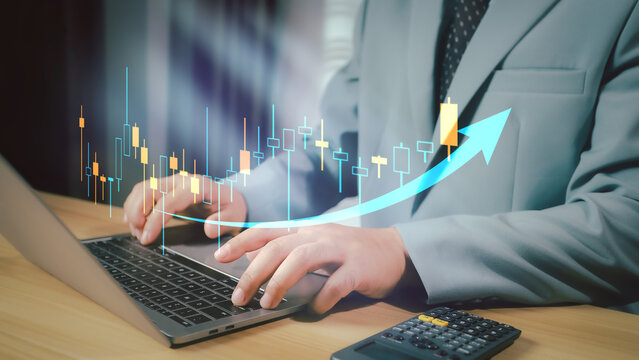 Financial growth and accounting analysis concept with businessman using calculator and virtual bar chart. Perfect for business success, revenue growth, finance report, and investment planning.