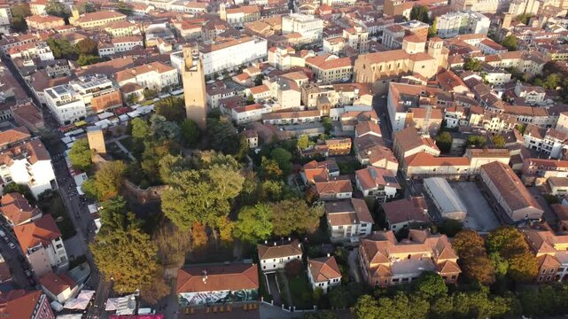 Aerial view of Rovigo&rsquo;s city center in Veneto, Italy, showing a blend of historic and modern architecture, red rooftops, and vibrant urban life.