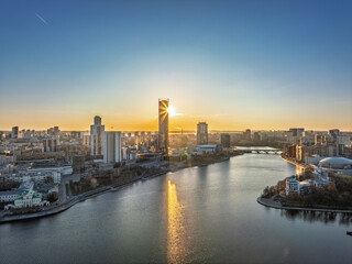 Fototapeta premium Yekaterinburg aerial panoramic view in spring at sunset. Yekaterinburg city and pond in spring or autumn.