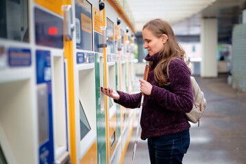 A woman with visual and hearing impairments buying a ticket at a ticket machine and paying by phone
