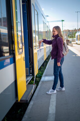 Portrait of blind woman with white cane standing on train station outdoors in city