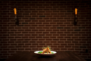 Plated Entrée in Dramatic Restaurant Lighting