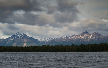Sun on mountains behind Lake Lucille in Alaska