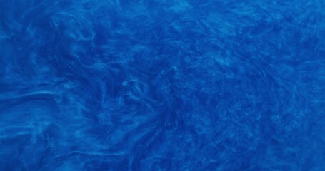 Abstract background. The blue shiny liquid is bubbling and shimmering