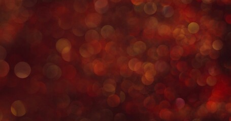 Abstract boho-style background. The red sparkles are bubbling and shimmering. Blurred sparkles.