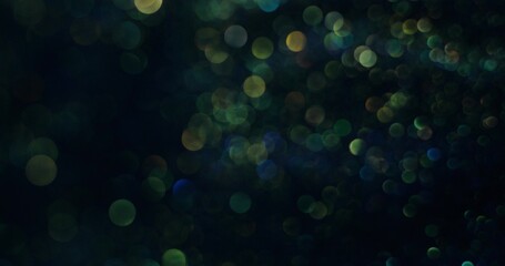 Abstract boho-style background. The blue-green sparkles are bubbling and shimmering. Blurred sparkles.