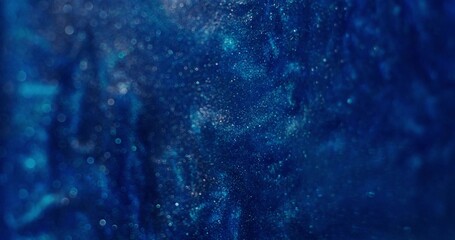 Abstract background. The blue paint with sparkles shimmers and boils