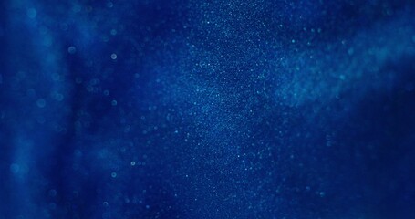 Abstract background. The blue paint with sparkles shimmers and boils