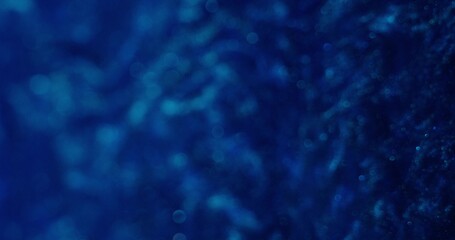 Abstract background. The blue paint with blurred sparkles shimmers and boils