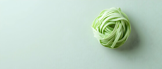 Light Green Pasta Nestled In Center On Pale Grey Surface