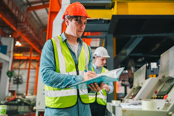 Engineer worker team of technicians collaborating on production line inside factory, wearing safety helmets reflective vests, performing inspection adjustments to ensure smooth industrial operations