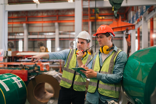 An industrial worker operates machinery in a modern factory environment focusing on production processes quality control mechanical operation workplace safety and efficient material handling