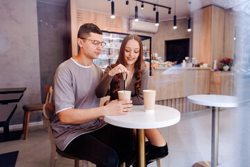 Couple enjoys coffee and conversation at modern cafe during cozy afternoon