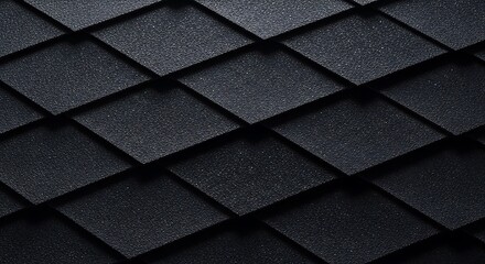 Fototapeta premium Modern black roof tiles close-up, textured geometric pattern, abstract architectural background, diagonal slate shingles with granular surface for roofing, construction, or design texture