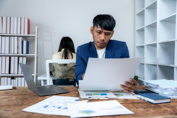 Focused Businessman Reviewing Documents in Office