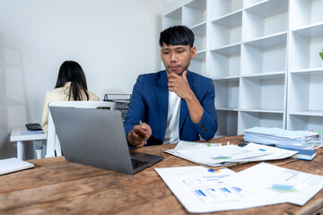 Thoughtful Businessman Working at Desk