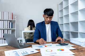 Man Analyzing Business Data at Desk
