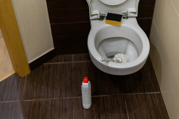 Man hand cleaning toilet with brush