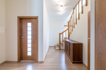 Bright Wooden Home Hallway Interior with Staircase and Attractive Furnishings