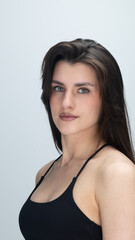 Portrait of confident young woman with long dark hair and brown eyes