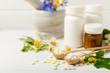 Alternative medicine herbal capsule organic drug on wooden background.Assortment of herbal and...